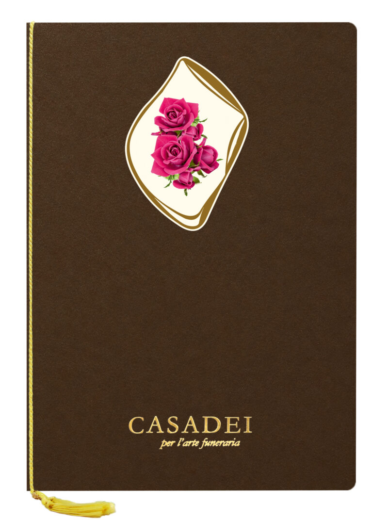Libro delle condoglianze con copertina sagomata ovale immagine Croce e rose in cartone bronzo, interno composto da una pagina "In memoria" e otto pagine per le firme in carta avorio, rilegato con cordoncino e nappa. 21x29,7 cm.