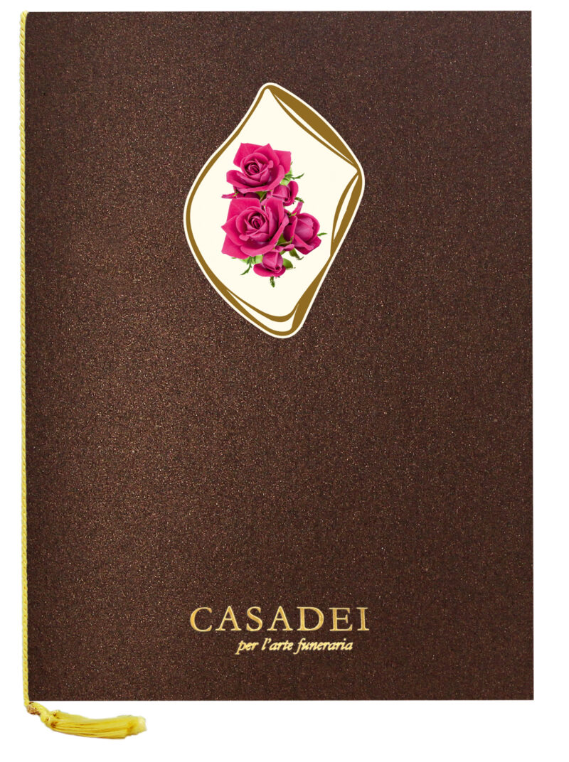 Libro delle condoglianze con copertina sagomata ovale immagine Croce e rose in cartone bronzo, interno composto da una pagina "In memoria" e otto pagine per le firme in carta avorio, rilegato con cordoncino e nappa. 21x29,7 cm.